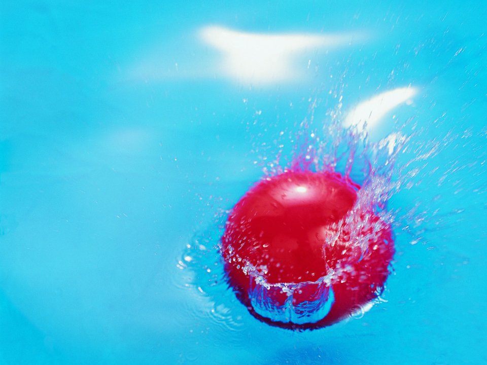 red_beach_ball_splashing_water