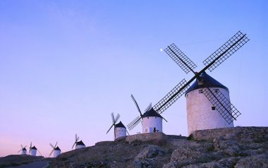 Spain, a row of tower windmills under the clear dawn sky in Consuegra