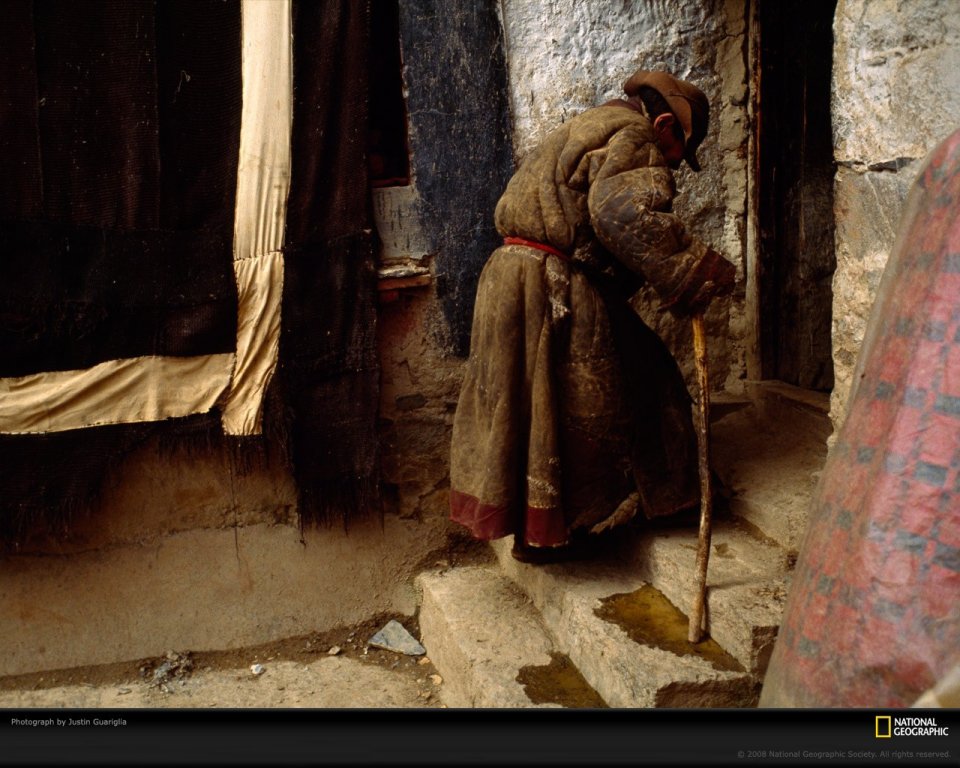 Tibetan Elder On Stone Steps With Cane